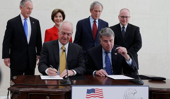 Bush Center president Mark Langdale, front left and national archivist David Ferriero, right, sign a joint use agreement for the George W. Bush Presidential Center Wednesday, April 24, 2013, in Dallas. At rear from left are board chairman of the George W. Bush Foundation Don Evans, former first lady Laura Bush, former president George W. Bush, and Bush Center Director Alan Lowe. (AP Photo/David J. Phillip) 