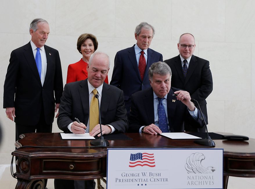 Bush Center president Mark Langdale, front left and national archivist David Ferriero, right, sign a joint use agreement for the George W. Bush Presidential Center Wednesday, April 24, 2013, in Dallas. At rear from left are board chairman of the George W. Bush Foundation Don Evans, former first lady Laura Bush, former president George W. Bush, and Bush Center Director Alan Lowe. (AP Photo/David J. Phillip)