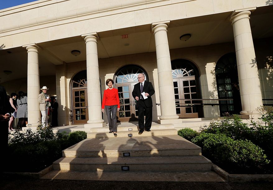 Former first lady Laura Bush and Alan Lowe, director of the library and museum enter a replica of the White House rose garden during a tour of the George W. Bush Presidential Center Wednesday, April 24, 2013, in Dallas. (AP Photo/David J. Phillip)