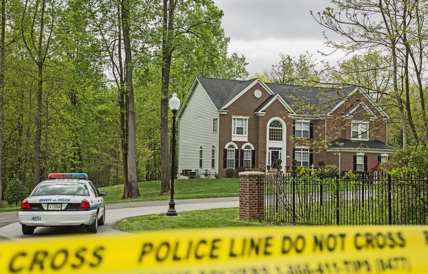 Police tape blocks off the driveway of the Upper Marlboro home of D.C. police Detective Joseph B. Newell, who was found fatally shot Monday. His stepson, Antwan Rayvon James, is accused of killing him. (Andrew S Geraci/The Washington Times)