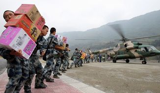 Chinese soldiers unload relief supplies from a helicopter in quake-ravaged Sichuan province. Saturday&#39;s 7.0-magnitude earthquake killed at least 186 and injured thousands. The military is in full control of relief and rescue, with citizen-initiated efforts to help strictly banned.