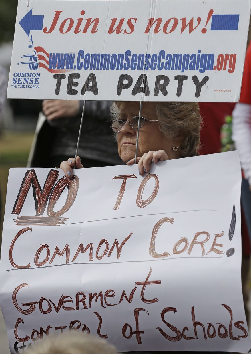 **FILE** Alabama Tea Party member Kay Day of Irvington, Ala., demonstrates in front of the Alabama Statehouse in Montgomery, Ala., as lawmakers gathered inside on Feb. 5, 2013, the first day of their regular legislative session. Day was protesting Alabama's efforts in the Common Core education guidelines. (Associated Press)