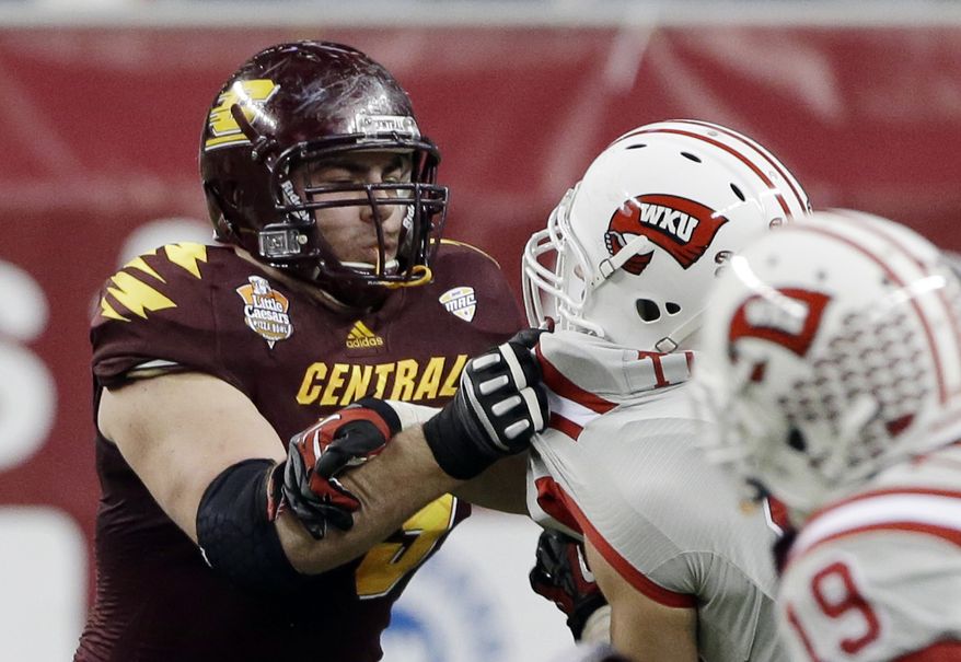 FILE - In this Dec. 26, 2012, file photo, Central Michigan offensive linesman Eric Fisher blocks against Western Kentucky during the second half of the Little Caesars Pizza Bowl NCAA college football game at Ford Field in Detroit. Only twice since the AFL-NFL merger in 1970 has an offensive tackle been drafted first overall. On Thursday night, the Kansas City Chiefs could make it three. Luke Joeckel and Fisher are the hot names to go No. 1, assuming the Chiefs still have the pick. (AP Photo/Carlos Osorio, File)