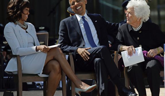 President Barack Obama laughs as he sits between his wife, first lady Michelle Obama and former first lady Barbara Bush after his speech during the dedication of the George W. Bush Presidential Center, Thursday, April 25, 2013, in Dallas. (AP Photo/David J. Phillip)