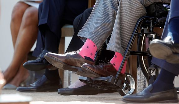 Former President George H.W. Bush, wears pink socks as he is seated in a wheelchair with, from left, first lady Michelle Obama, President Barack Obama, former first lady Barbara Bush, and former President George W. Bush, at the dedication of the George W. Bush presidential library on the campus of Southern Methodist University in Dallas, Thursday, April 25, 2013. (AP Photo/Charles Dharapak)