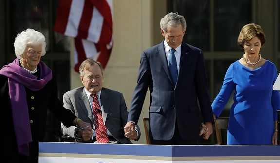 From left, former first lady Barbara Bush, President George H.W. Bush, former president George W. Bush and former first lady Laura Bush holds hands during the invocationduring the dedication of the George W. Bush Presidential Center Thursday, April 25, 2013, in Dallas. (AP Photo/David J. Phillip) 