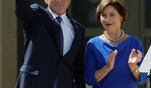Former president George W. Bush waves with  his wife Laura speech during the dedication of the George W. Bush Presidential Center Thursday, April 25, 2013, in Dallas. (AP Photo/David J. Phillip) 