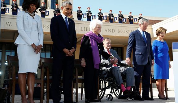 President Barack Obama and first lady Michelle Obama stand with former Presidents George W. Bush, George H.W. Bush, and their wives, former first ladies Barbara Bush, and Laura Bush amd bow their heads in prayer at the dedication of the George W. Bush presidential library on the campus of Southern Methodist University in Dallas, Thursday, April 25, 2013. (AP Photo/Charles Dharapak)