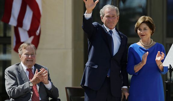 Former president George H.W. Bush, left, applauds with Laura Bush after former president George W. Bush&#39;s speech during the dedication of the George W. Bush Presidential Center Thursday, April 25, 2013, in Dallas. (AP Photo/David J. Phillip) 