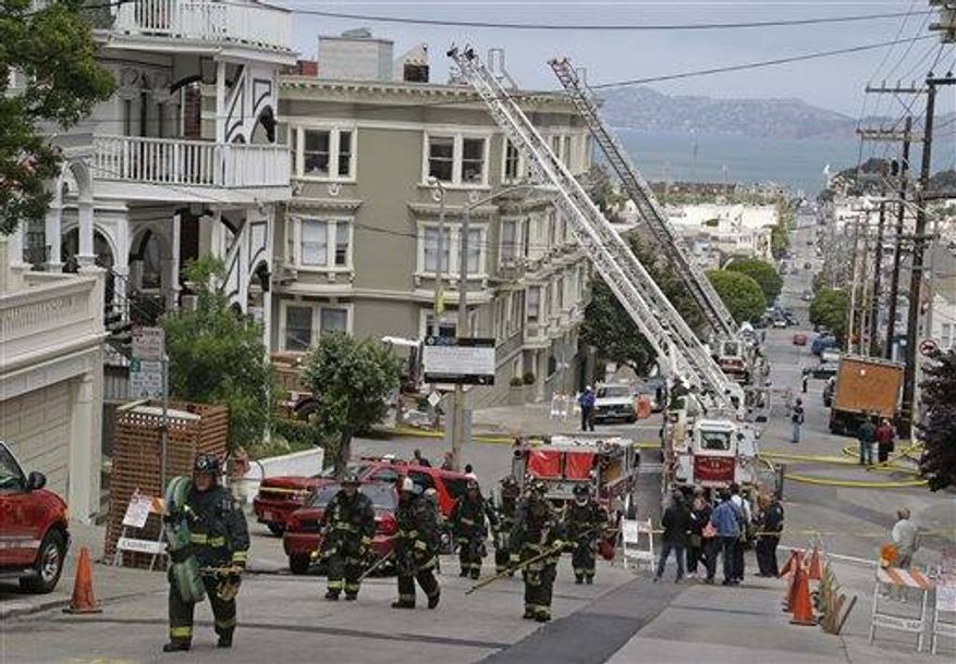 A group of San Francisco firemen make their way up a hill after a fire was contained at a multi-unit Pacific Heights building in San Francisco, April 24, 2013. Some San Francisco firefighters are raking in six-figure overtime paychecks because of staffing shortages that have department managers scheduling numerous extra shifts, a newspaper reported.