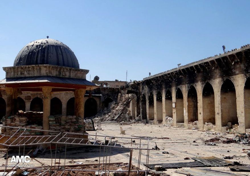 This journalism image provided by Aleppo Media Center AMC, which has been authenticated based on its contents and other AP reporting, shows the damaged famed 12th century Umayyad mosque without the minaret, background right corner, which was destroyed by the shelling, in the northern city of Aleppo, Syria, Wednesday April 24, 2013. (AP Photo/Aleppo Media Center, AMC)