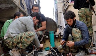 This citizen journalism image taken on April 25, 2013 and provided by Aleppo Media Center AMC, which has been authenticated based on its contents and other AP reporting, shows members of the free Syrian Army preparing their weapons in the neighborhood of al-Amerieh in Aleppo, Syria. (Associated Press/Aleppo Media Center AMC)