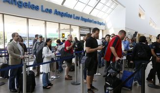 ** FILE ** Travelers stand in line at Los Angeles International Airport on Monday, April 22, 2013. (Associated Press)
