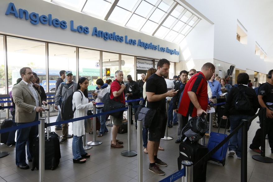 ** FILE ** Travelers stand in line at Los Angeles International Airport on Monday, April 22, 2013. (Associated Press)