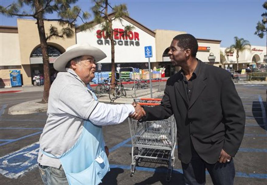 Former child actor Rodney Allen Rippy, a losing candidate for Mayor of Compton, Ca., poses for a photo with an unidentified supporter near Compton City Hall. (AP Photo/Damian Dovarganes)
