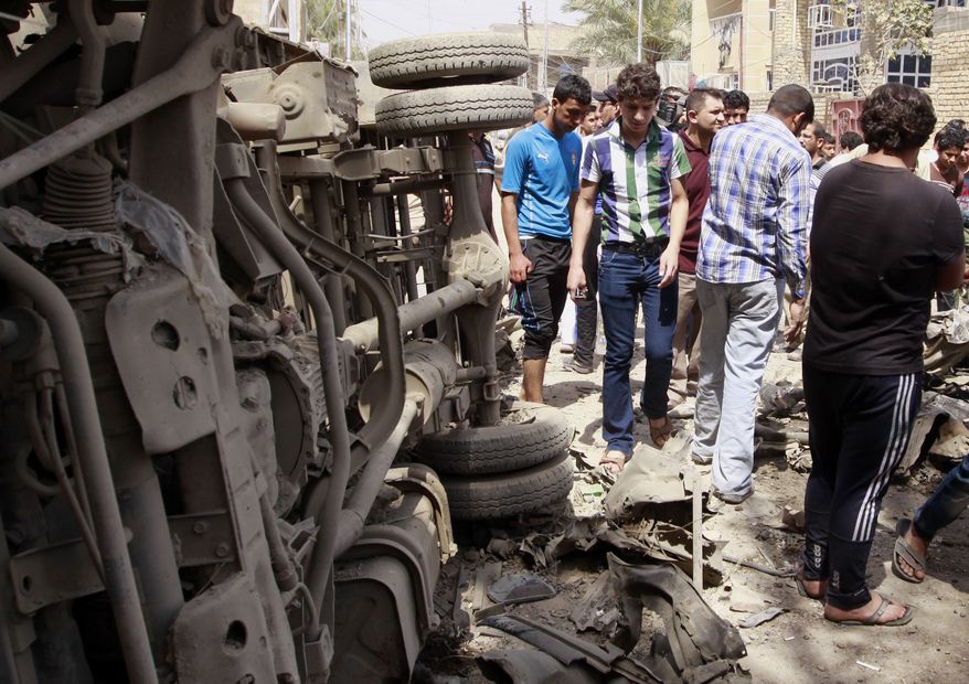 ** FILE ** Civilians gather at the scene of a car bomb attack in east Baghdad's neighborhood of Kamaliya, Iraq, Monday, April 15, 2013. Five car bombs exploded in Iraqi areas dominated by Shiites on Monday, April 29, 2013, killing 26 civilians and injuring dozens more. (AP Photo/ Khalid Mohammed)