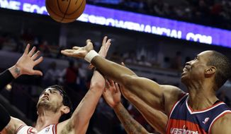 **FILE** Washington Wizards center Jason Collins (right) battles for a rebound against Chicago Bulls guard Kirk Hinrich during the first half of the Bulls&#x27; 95-92 win in Chicago on April 17, 2013. (Associated Press)