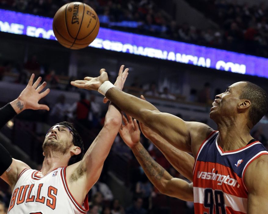 Washington Wizards center Jason Collins (right) battles for a rebound against Chicago Bulls guard Kirk Hinrich during the first half of an NBA basketball game in Chicago on Wednesday, April 17, 2013. Collins has become the first male professional athlete in the four major sports leagues to come out as gay. (AP Photo/Nam Y. Huh)
