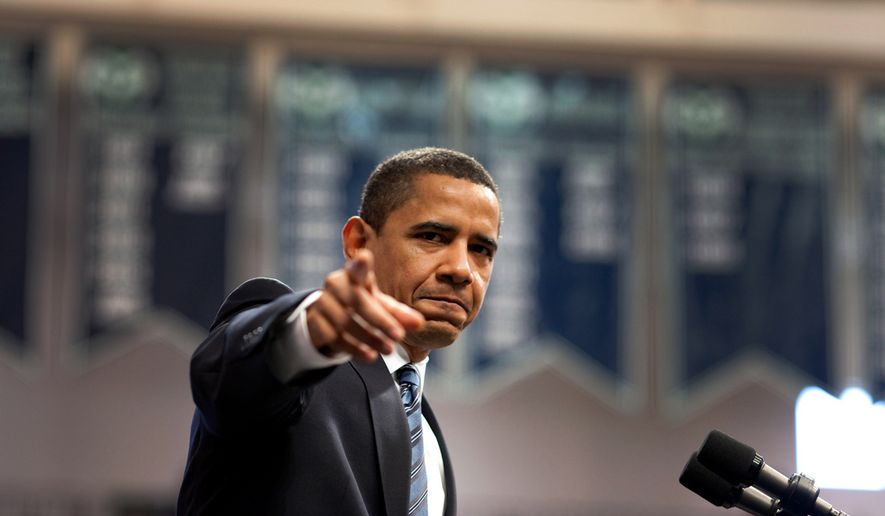 ** FILE ** President Obama points to a member of the audience at a meeting in Rio Rancho, New Mexico, May 14, 2009. (Official White House Photo by Pete Souza)
