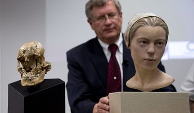 The Smithsonian&#x27;s Doug Owsley displays the skull and facial reconstruction of  &quot;Jane of Jamestown&quot; at the National Museum of Natural History in Washington, where scientists presented evidence that some of the earliest American colonists at Jamestown, Va., survived harsh conditions by turning to cannibalism. (AP Photo/Carolyn Kaster)