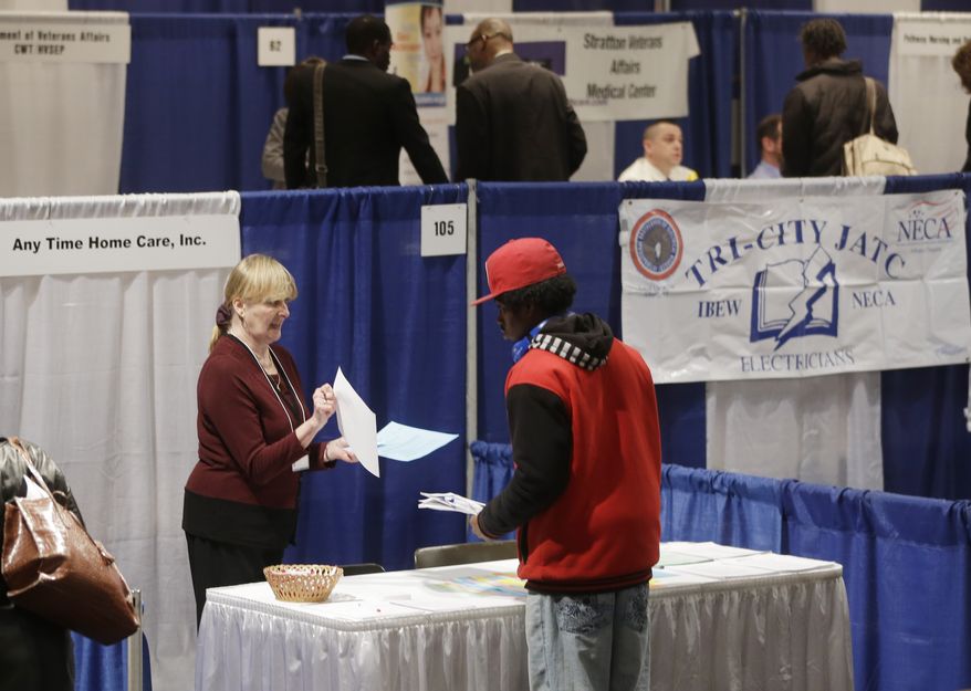Kathie Maiello (left) of Any-Time Home Care talks with Jashod Chaney of Albany, N.Y., at the Dr. King Career Fair at the Empire State Plaza Convention Center in Albany on Thursday, April 11, 2013. (AP Photo/Mike Groll)
