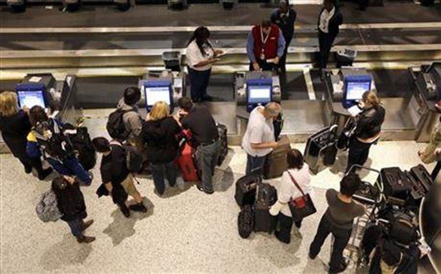 ** FILE ** Airline passengers check-in at George Bush Intercontinental Airport Tuesday, Nov. 20, 2012, in Houston. Americans can expect airports to be busier and planes to be fuller than ever, according to a forecast by the main trade association for U.S. airlines released ahead of the holiday. (AP Photo/David J. Phillip