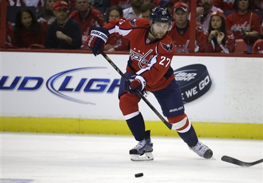Karl Alzner deflected the puck over the glass in Game 2 Saturday, but his was not one of two delay-of-game penalties called. (Associated Press)