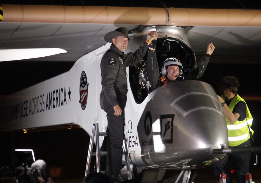 Andre Borschberg (left), Solar Impulse co-founder, CEO and pilot, greets pilot Bertrand Piccard at Sky Harbor International Airport in Phoenix early on Saturday, May 4, 2013, after Mr. Piccard completed the first leg of the Solar Impulse aircraft's coast-to-coast flight. (AP Photo/Scuteri)