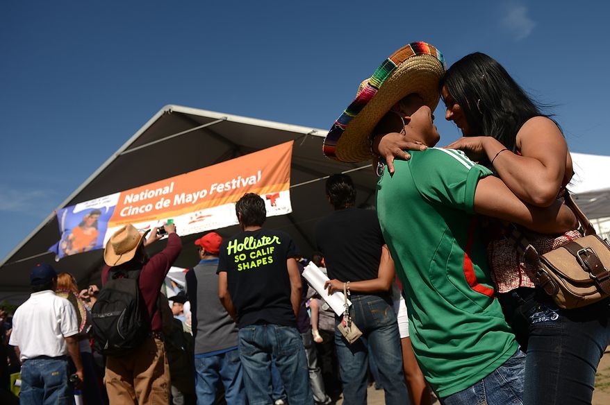 Pedro Hernandez of Washington dances with his girlfriend to music by a live mariachi band at the annual Cinco de Mayo celebration on the National Mall in Washington on Sunday, May 5, 2013. (Andrew Harnik/The Washington Times)
