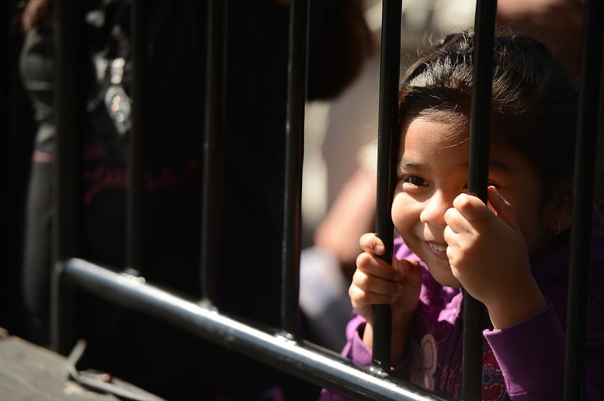 A young girl watches performances onstage at the annual Cinco de Mayo celebration on the National Mall in Washington on Sunday, May 5, 2013. (Andrew Harnik/The Washington Times)