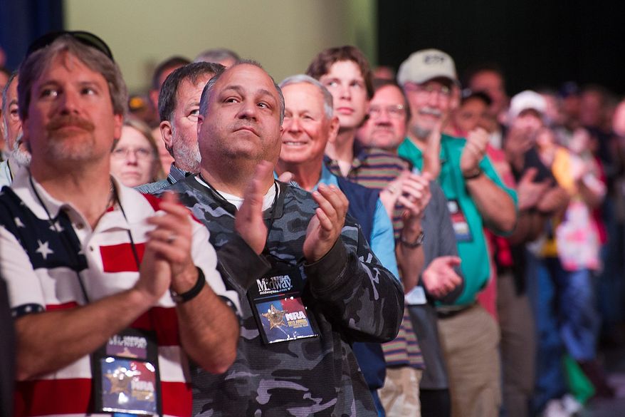 Attendees applaud a speaker during the leadership forum at the National Rifle Association's annual convention Friday, May 3, 2013 in Houston. (AP Photo/Steve Ueckert)
