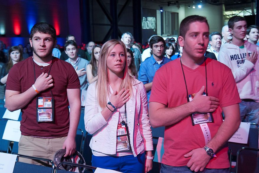 Attendees recite the Pledge of Allegiance during the opening of the leadership forum at the National Rifle Association's annual convention Friday, May 3, 2013 in Houston. (AP Photo/Steve Ueckert)