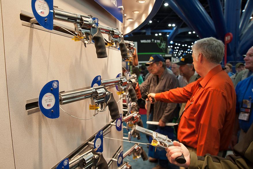 ** FILE ** Smith and Wesson pistols are on display during the National Rifle Association's annual convention Friday, May 3, 2013, in Houston. (AP Photo/Steve Ueckert)