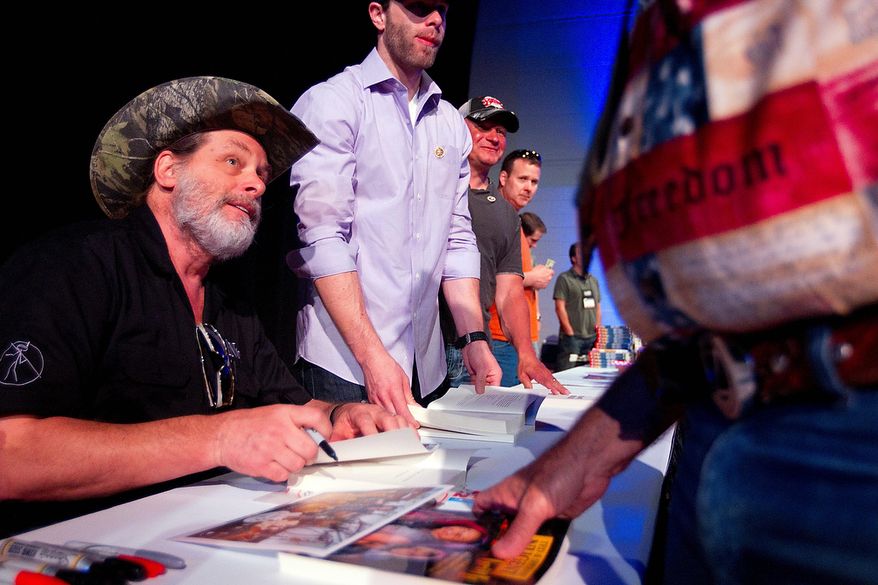 ** FILE ** NRA member and musician, Ted Nugent, greets fans and signs autographs at the National Rifle Association's 142 Annual Meetings and Exhibits in the George R. Brown Convention Center Sunday, May 5, 2013, in Houston. (AP Photo/Houston Chronicle, Johnny Hanson)