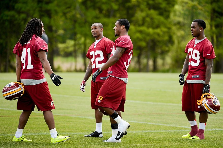 Newly drafted Washington Redskins safety Phillip Thomas (left), cornerback David Amerson (second from right) and safety Bacarri Rambo (right) talk on the sidelines during the team's rookie minicamp at Redskins Park in Ashburn, Va., on Sunday, May 5, 2013. Also pictured is tryout cornerback Akeem Auguste (second from left). (Andrew Harnik/The Washington Times)