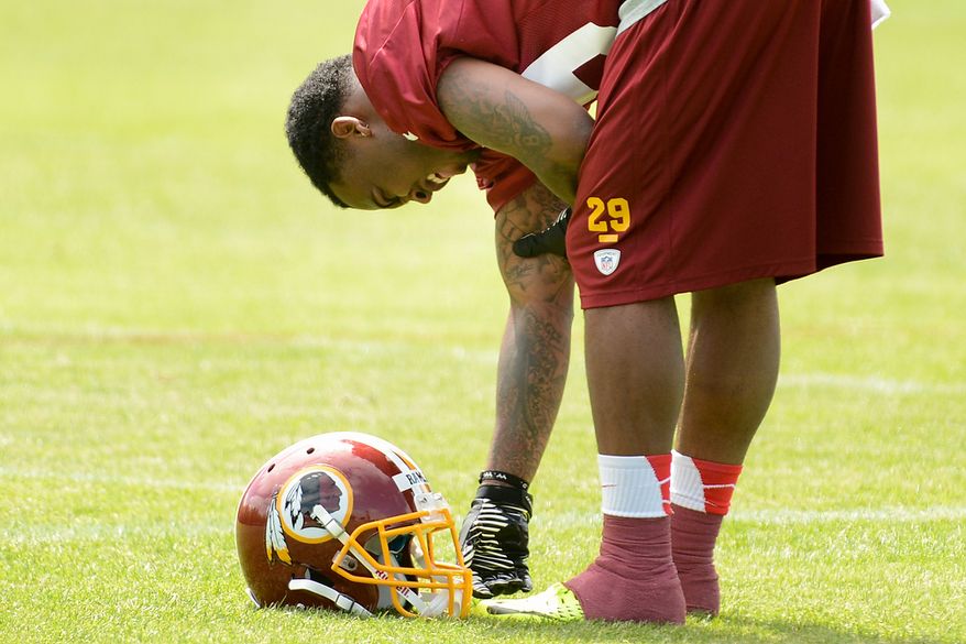 Washington Redskins safety Bacarri Rambo (29) grimaces and holds his arm after making an interception during a scrimmage at the Washington Redskins' rookie minicamp at Redskins Park in Ashburn, Va., on Sunday, May 5, 2013. (Andrew Harnik/The Washington Times)