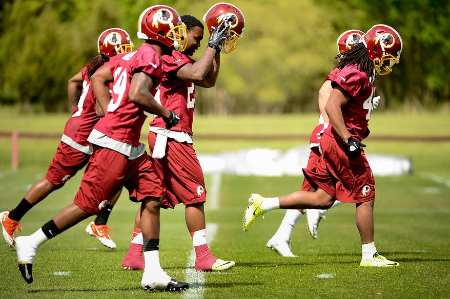 Newly drafted Washington Redskins safety Bacarri Rambo (29) puts on his helmet during the Washington Redskins' rookie minicamp at Redskins Park, Ashburn, Va., Sunday, May 5, 2013. (Andrew Harnik/The Washington Times)