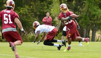 Washington Redskins safety Bacarri Rambo (29) makes an interception during a scrimmage at the team&#39;s rookie minicamp at Redskins Park in Ashburn, Va., on Sunday, May 5, 2013. (Andrew Harnik/The Washington Times)