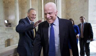Sen. John McCain, R-Ariz., laughs as he and Sen. Chuck Schumer, D-N.Y., left, cross paths at competing TV news interviews just before a vote in the Senate on legislation to collect sales tax on internet purchases, on Capitol Hill in Washington, Monday, May 6, 2013. (Associated Press)
