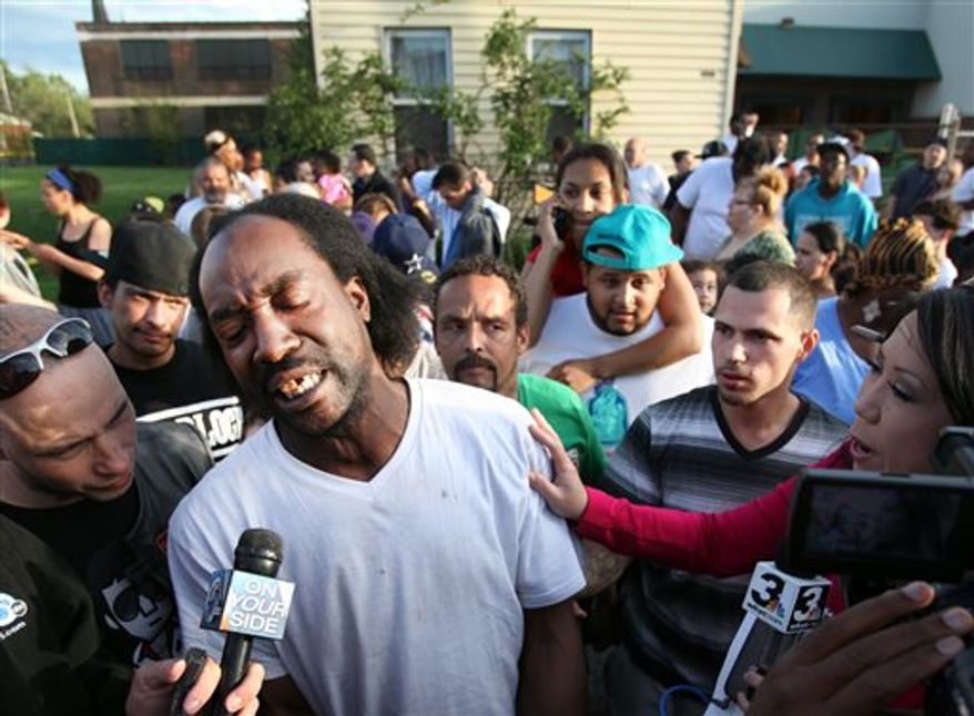 ** FILE ** Neighbor Charles Ramsey speaks to media near the home on the 2200 block of Seymour Avenue, where three missing women were rescued in Cleveland, on Monday, May 6, 2013. (AP Photo/The Plain Dealer, Scott Shaw)