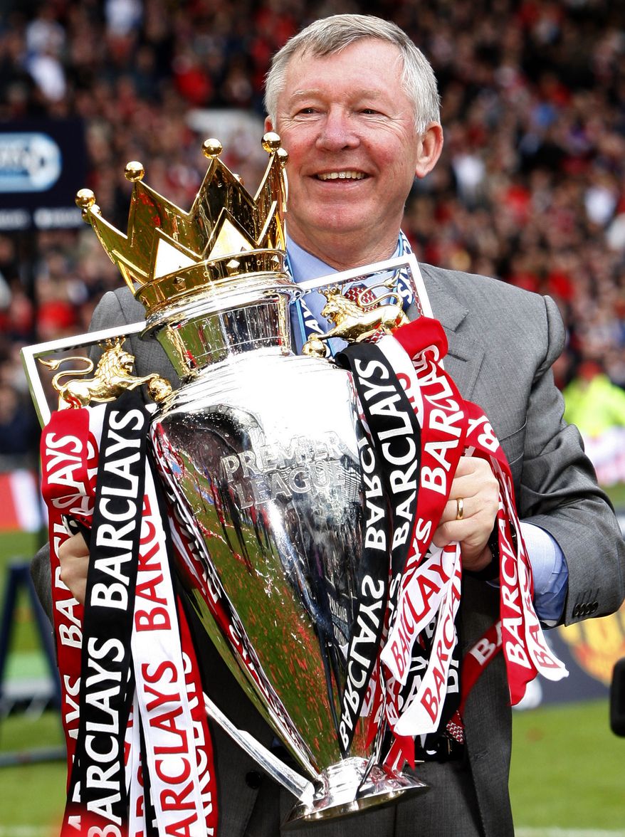 FILE - In this Saturday May 16, 2009 file photo Manchester United's manager Sir Alex Ferguson holds the English Premier League trophy as his team celebrate winning the league after their team's 0-0 draw against Arsenal at Old Trafford Stadium, Manchester, England. Manchester United said Wednesday May 8, 2013 that manager Alex Ferguson is retiring at the end of season. (AP Photo/Jon Super, File)