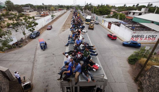 ** FILE ** Migrants ride on top of a northbound train toward the U.S.-Mexico border in Juchitan in southern Mexico on Monday, April 29, 2013. Migrants crossing Mexico to get to the U.S. have increasingly become targets of criminal gangs who kidnap them to obtain ransom money. (AP Photo/Eduardo Verdugo)