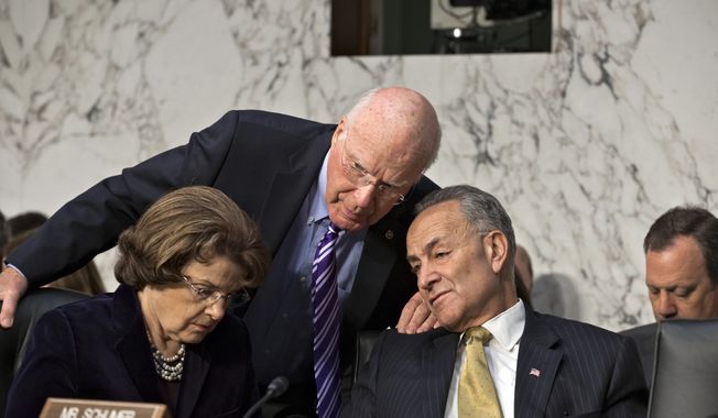 **FILE** Senate Judiciary Committee Chairman Patrick Leahy (center), Vermont Democrat, speaks with committee members and Democratic Sens. Charles Schumer (right) of New York and Dianne Feinstein of California on Capitol Hill in Washington on April 22, 2013, during the committee&#x27;s hearing on immigration reform. (Associated Press)