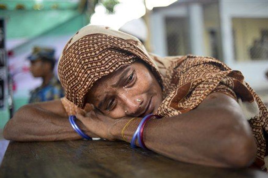 A Bangladeshi woman cries after failed attempts on finding her missing daughter at a makeshift morgue in Savar, near Dhaka, Thursday, May 9, 2013, after the collapse of a garment factory building. (AP Photo/Ismail Ferdous)