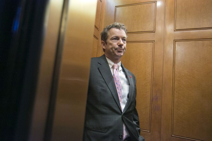 **FILE** Sen. Rand Paul, Kentucky Republican, is questioned by reporters in an elevator as he leaves a GOP policy meeting on Capitol Hill in Washington on March 7, 2013. (Associated Press)