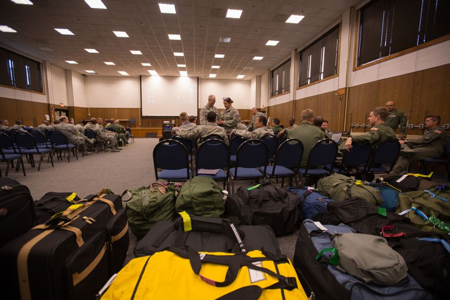 Reservists attached to the 459th Air Refueling Wing pack their bags on May 10, 2013, at Joint Base Andrews, Md., and discuss their upcoming deployment that will take place next week in support of Operation Enduring Freedom. The unit will deploy to the 379th Air Expeditionary Wing in an undisclosed location in southwest Asia and will provide aerial refueling in support of the operation. (Andrew S. Geraci/The Washington Times)