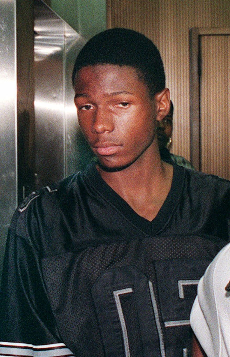 **FILE** Malcolm Shabazz, the grandson of political activist Malcolm X, leaves Family Court in Yonkers, N.Y., on July 29, 1999, after a detention hearing. In 1997, Shabazz, then 12, set a fire at the Yonkers home of his grandmother, Betty Shabazz, Malcolm X’s widow. (Associated Press)