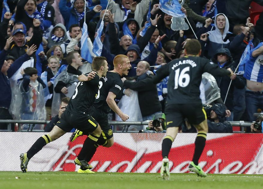 Wigan Athletic's Ben Watson, center, celebrates his goal against Manchester City with teammates during their English FA Cup final soccer match at Wembley Stadium, London, Saturday, May 11, 2013. (AP Photo/Jon Super)