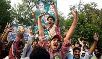 Pakistan Muslim League party supporters celebrate their party&#39;s victory in the parliamentary election in Lahore, Pakistan, on Sunday. Nawaz Sharif is the likely next prime minister. (Associated Press)