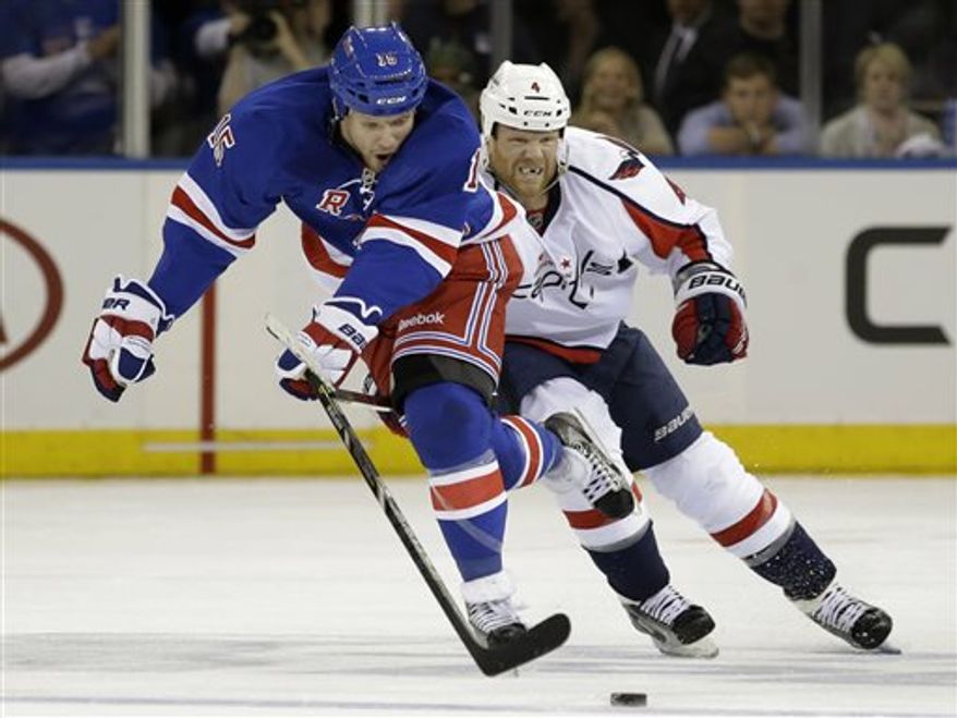 New York Rangers right wing Derek Dorsett (15) skates with Washington Capitals defenseman John Erskine (4) in pursuit in the second period of Game 6 of their NHL Stanley Cup hockey playoff series in New York, Sunday, May 12, 2013. The Rangers shut out the Capitals 1-0. (AP Photo/Kathy Willens)
